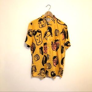 Men’s short sleeve abstract faces button up